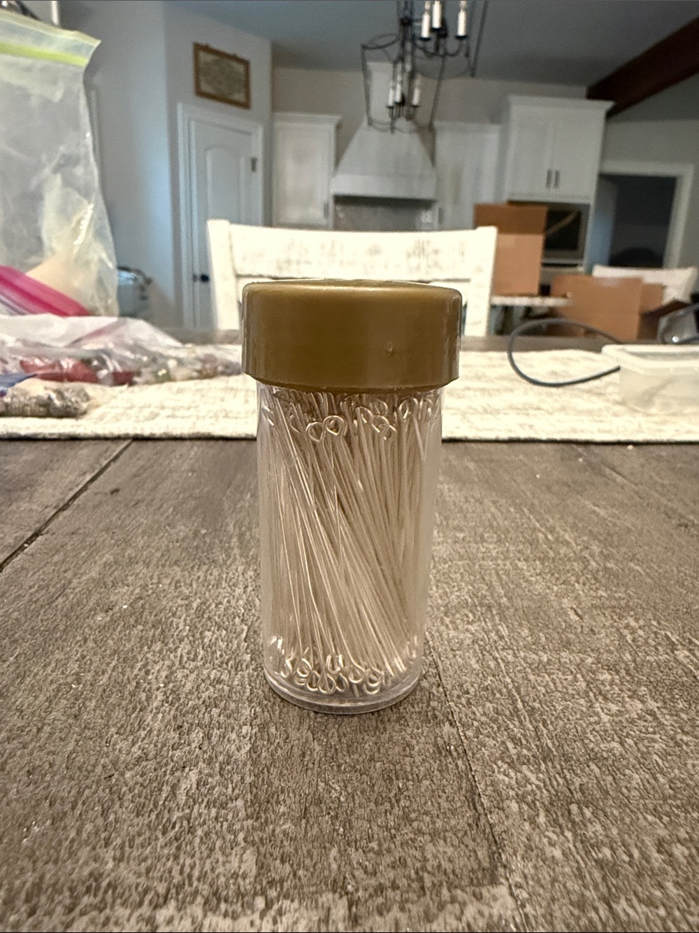 Clear Plastic Jar of Silver Pins with Olive Cap